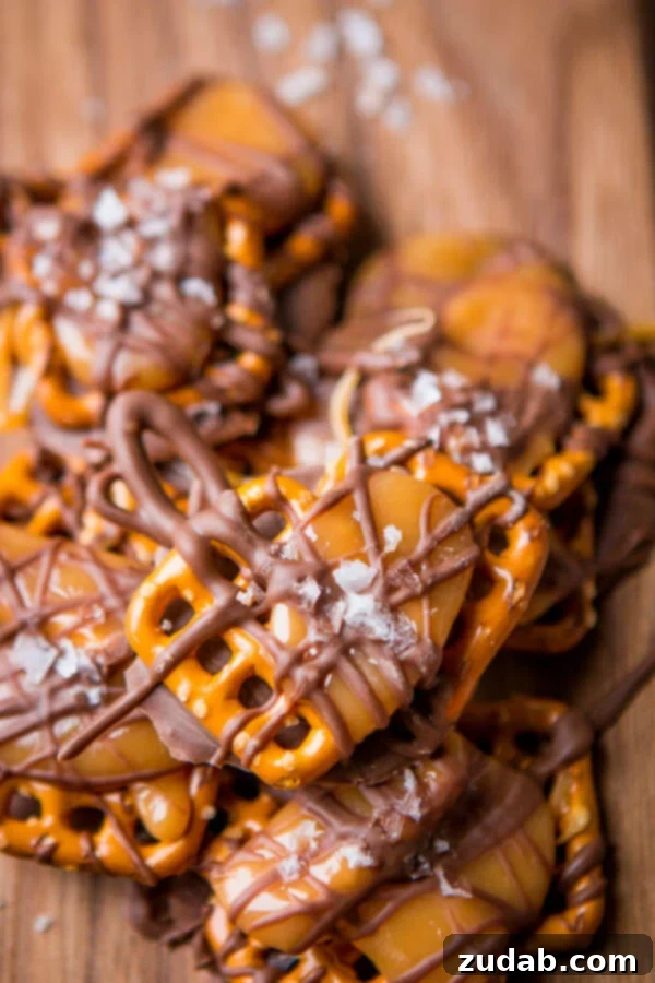 Easter M&M Pretzel Bites 7 A close-up of Salted Caramel Pretzel Snaps, featuring a golden caramel layer nestled between a pretzel base and a chocolate topping, with a hint of sea salt.