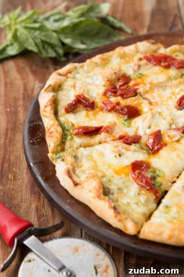 Achieving the Ideal Thin Crust for Your Creamy Pesto Chicken Pizza Close-up of a slice of Creamy Pesto Chicken Pizza showcasing the perfect golden thin crust.