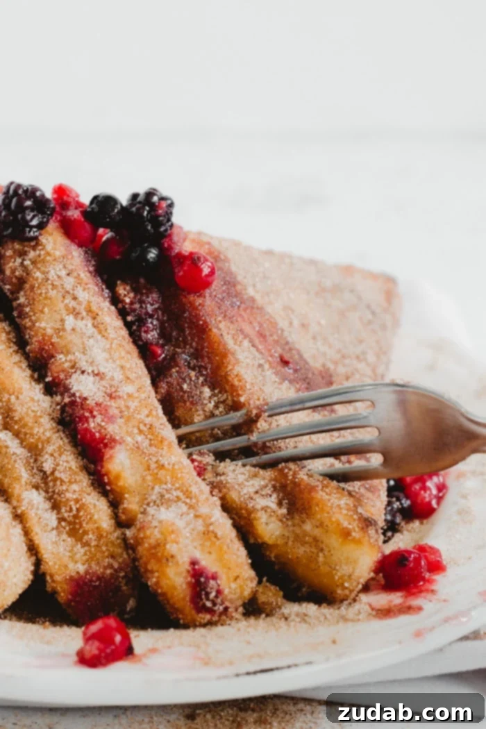 Crispy Puffy French Toast draining on paper towel