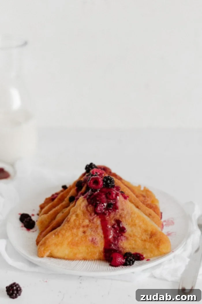 Puffy French Toast with powdered sugar and berries
