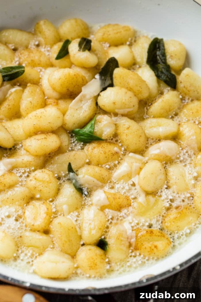Easy 10-Minute Brown Butter Sage Gnocchi 2 A white skillet with gnocchi and brown butter sage sauce