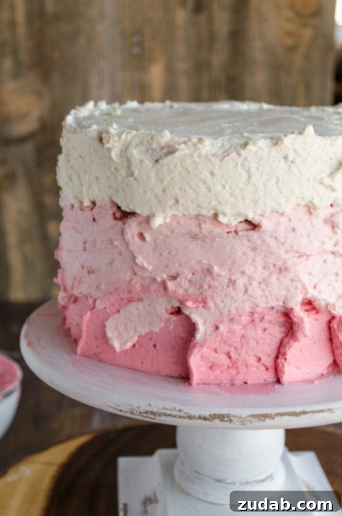 Blushing Strawberry Ombre Cake 11 A three-layer cake is topped with three shades of pink frosting, each layer featuring a rustic, textured finish that adds charm and character, waiting to be smoothed.