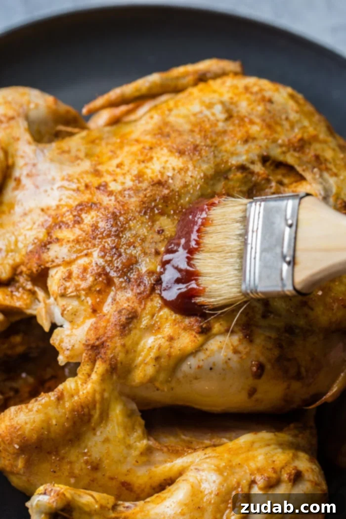 A red and white checkered napkin under a grey plate with a bbq instant pot whole chicken on top! 