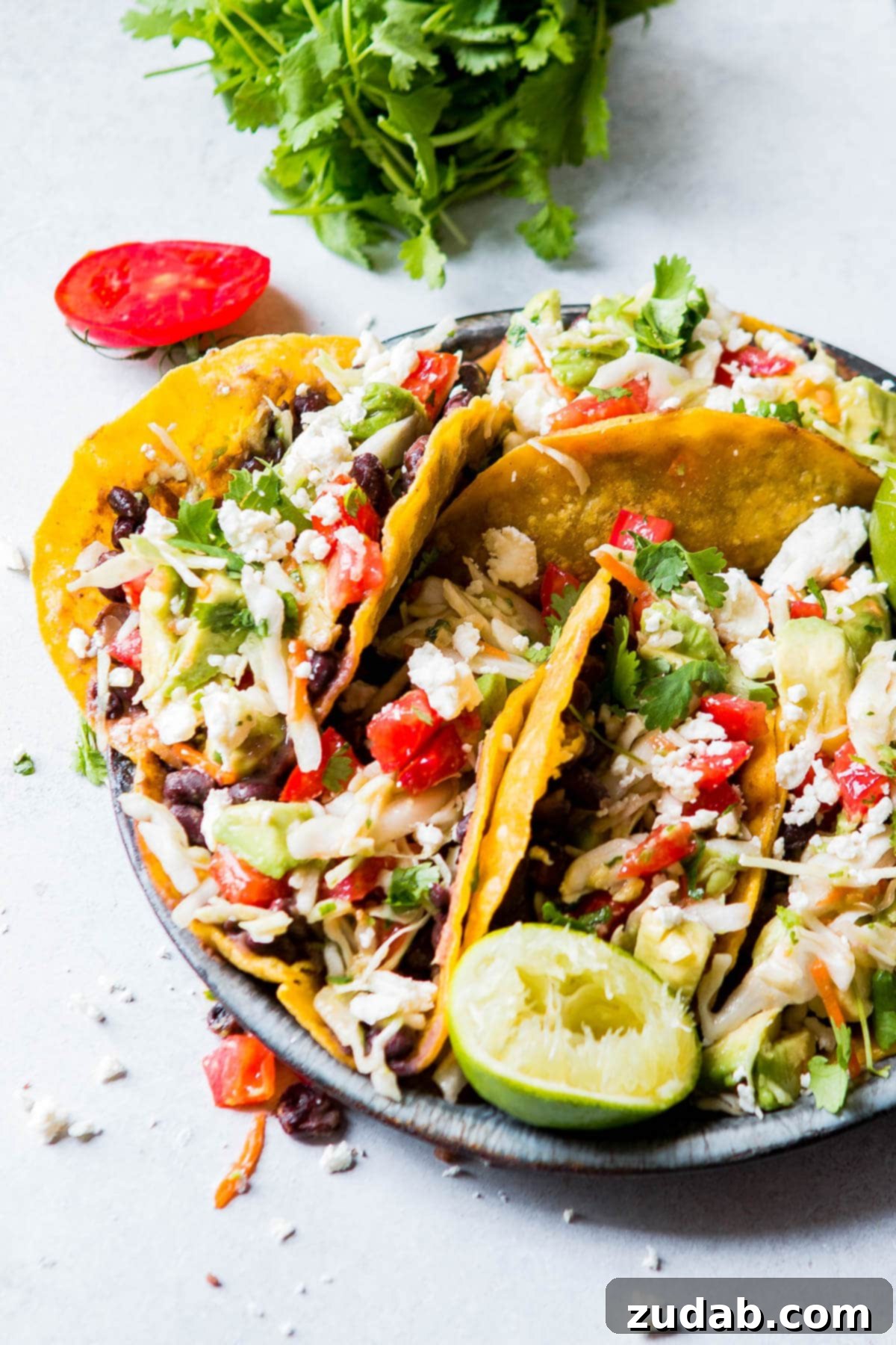 crispy vegetarian tacos on gray plate 