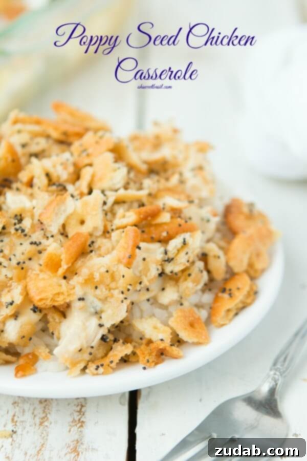 Everyone's favorite Poppy Seed Chicken Casserole with ritz crackers ohsweetbasil.com poppy seed chicken casserole on a white plate