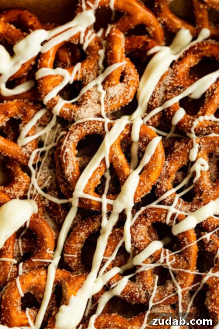Easy 4-Ingredient Cinnamon Sugar Pretzels 2 A vibrant overhead shot of several cinnamon sugar pretzels, artfully drizzled with white chocolate, presented invitingly.