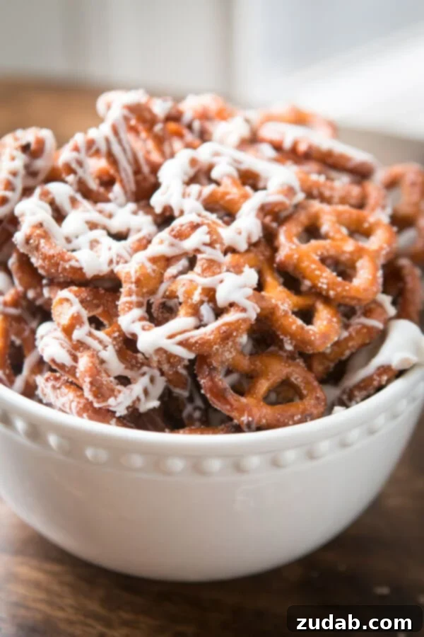 Cinnamon sugar pretzels are one of our all time favorite snacks or treats. Adults and kids cannot stay out of the bowl. Trust me! A close-up shot of irresistible cinnamon sugar pretzels, hinting at their addictive sweet and salty flavor. ohsweetbasil.com