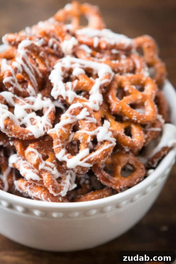Cinnamon sugar pretzels are one of our all time favorite snacks or treats. Adults and kids cannot stay out of the bowl. Trust me! Handfuls of cinnamon sugar pretzels with white chocolate drizzle, perfect for snacking. ohsweetbasil.com