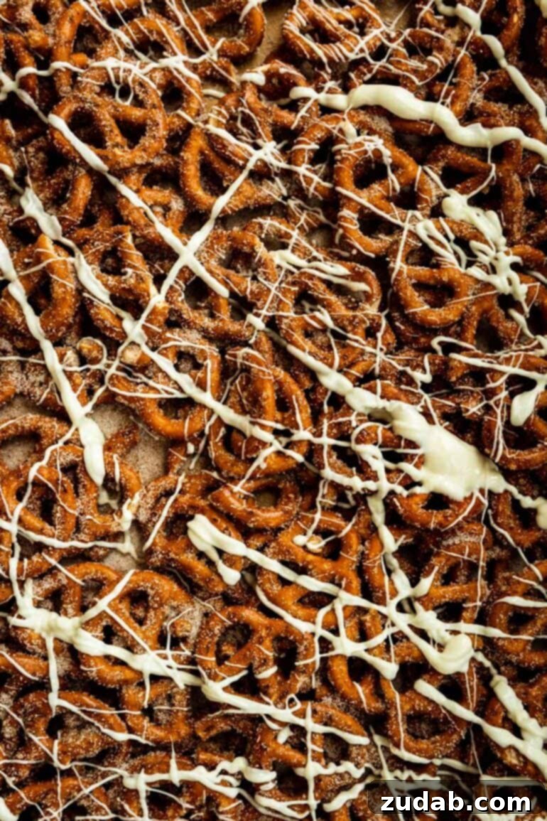 Easy 4-Ingredient Cinnamon Sugar Pretzels 5 A baking sheet generously filled with cinnamon sugar pretzels, each adorned with a delicate white chocolate drizzle.