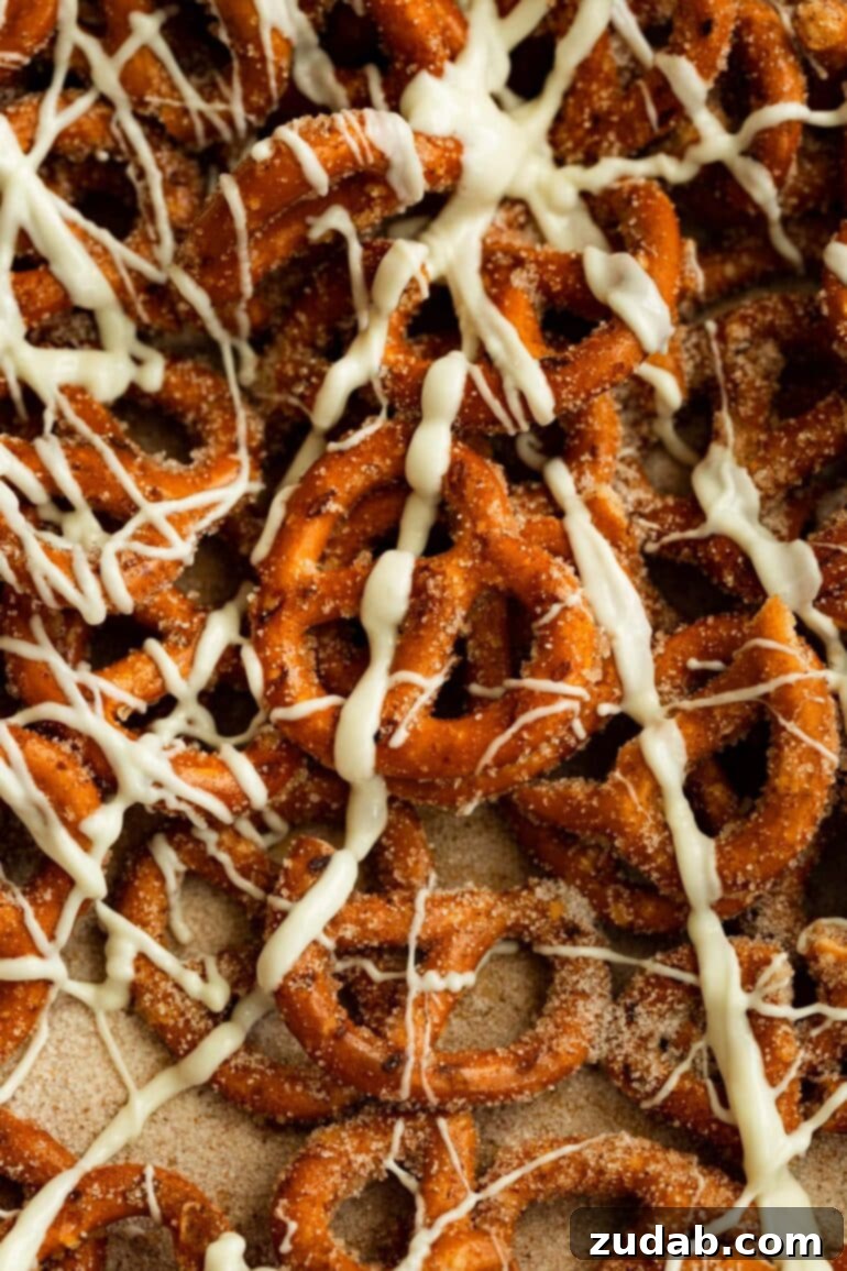 Easy 4-Ingredient Cinnamon Sugar Pretzels 6 A beautifully composed shot of cinnamon sugar pretzels, generously adorned with a tempting white chocolate drizzle, ready to be enjoyed.