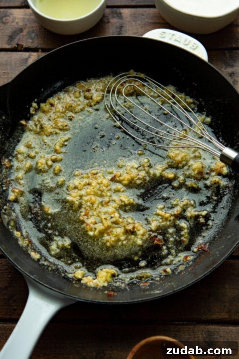 Chicken Florentine 6 Close-up of creamy Florentine sauce simmering in a skillet with spinach