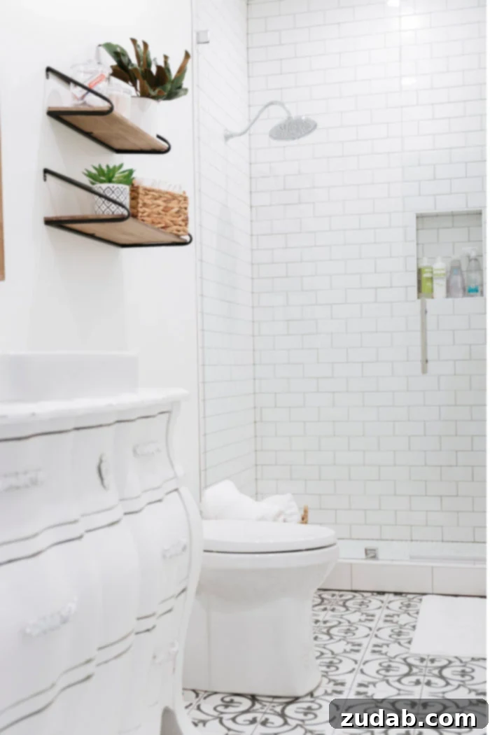 Basement Bathroom Transformation With The Best Tile of 2018 5 Elegant black and white guest bathroom featuring a repurposed dresser vanity and a sleek, frameless glass shower.