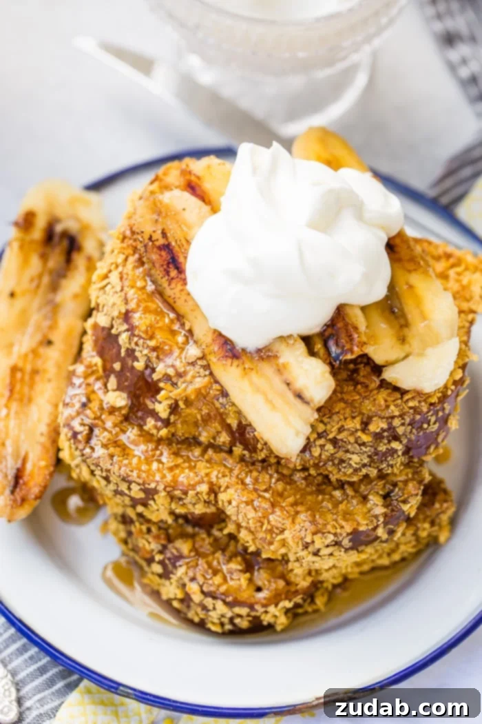 Cade's Signature Bananas Foster French Toast 3 A stack of golden brown Bananas Foster French Toast with whipped cream, ready to be enjoyed.