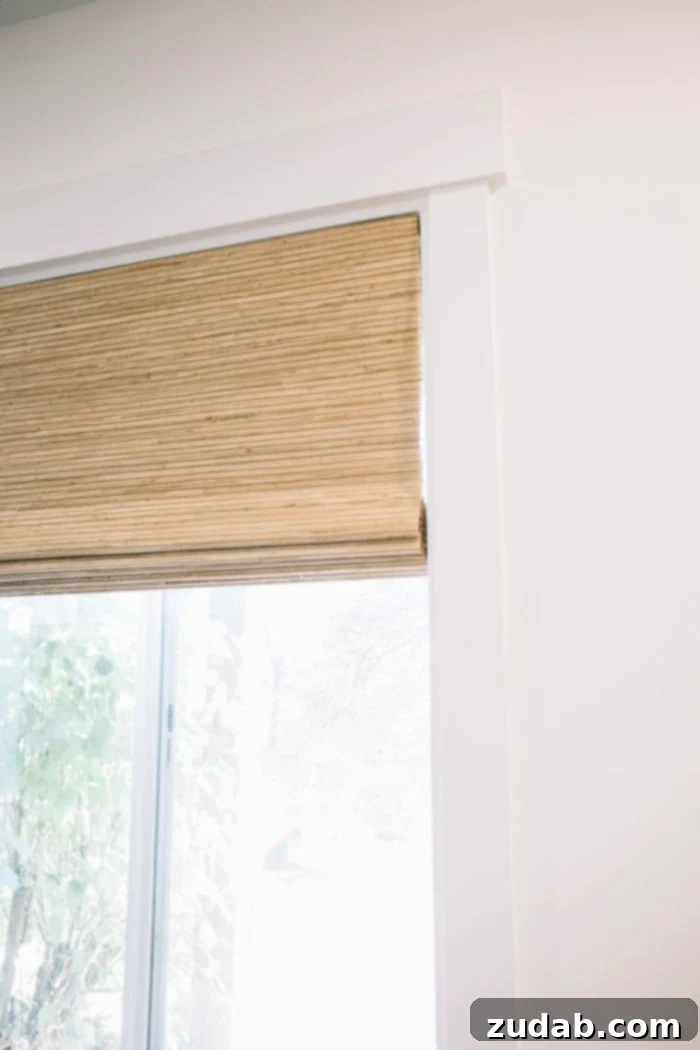 Stunning Basement Bedroom Makeovers 4 Close-up of natural weave cordless blinds for windows, showcasing their texture and clean, safe design. The light filtering through highlights the quality of the material and the seamless operation without visible cords.