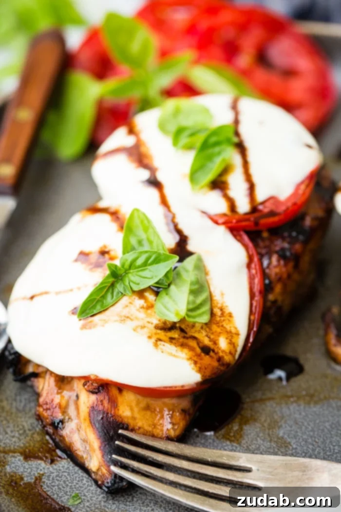 Balsamic Caprese Chicken with juicy tomatoes, melted mozzarella, and fresh basil drizzle