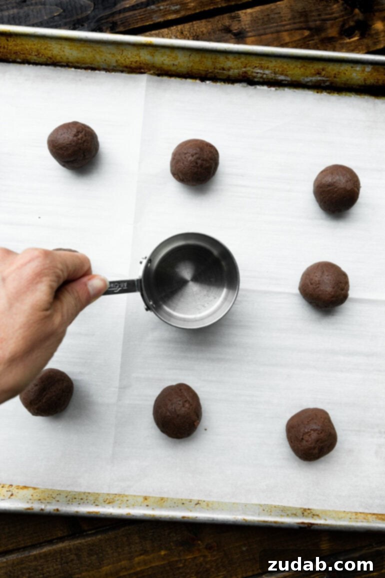 Craft Your Own Delicious Oreos 4 A close-up photo of a frosted chocolate cookie before being topped with another cookie, showing the creamy filling.