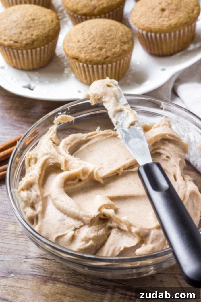 Fragrant Spice Cupcakes with Zesty Cinnamon Cream Cheese Frosting 5 A pristine bowl of freshly prepared cinnamon cream cheese frosting, showcasing its smooth texture and readiness to adorn spice cake cupcakes.