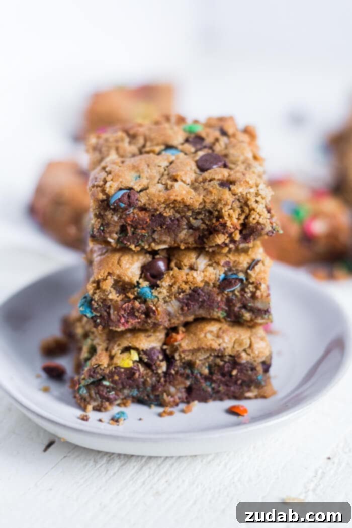 Loaded Flourless Monster Cookie Bars 5 A batch of flourless monster cookie bars, perfect for a gluten-free dessert or snack, showcased on a cooling rack