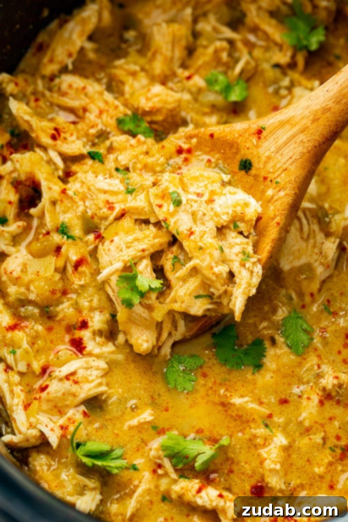 Tangy Pineapple Mexican Shredded Chicken for Instant Pot and Slow Cooker 3 a slow cooker full of shredded chicken in a salsa verde pineapple sauce