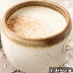 Snowman Milk Creamy White Hot Chocolate 11 A photo of a mug full of warm vanilla milk and topped with a sprinkle of cinnamon
