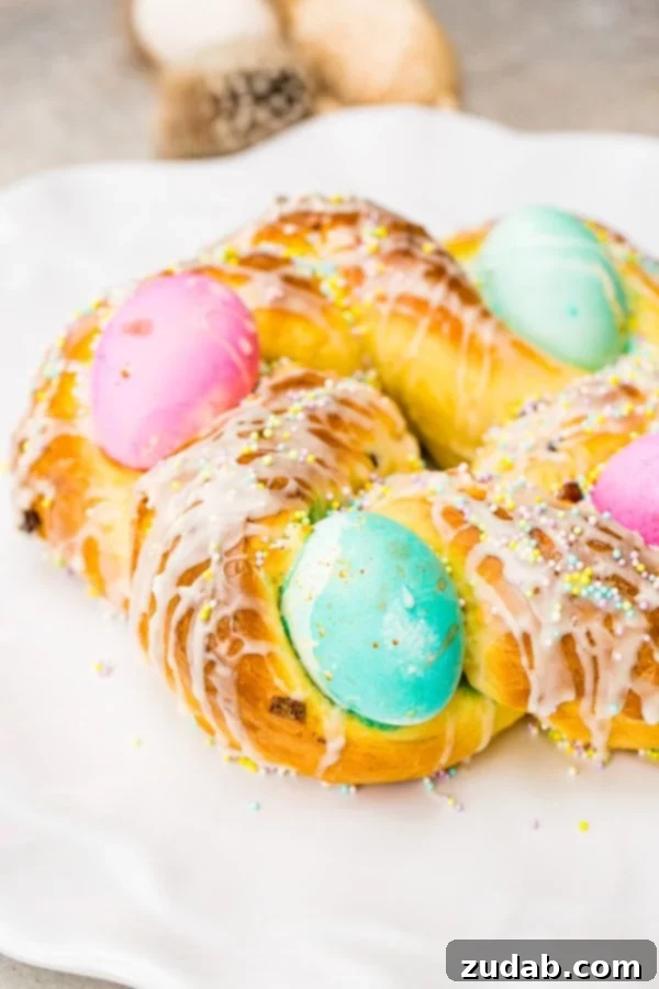Sweet Italian Easter Bread 2 A beautifully braided Italian Easter bread wreath, adorned with vibrant hard-boiled eggs, sweet glaze, and colorful sprinkles.
