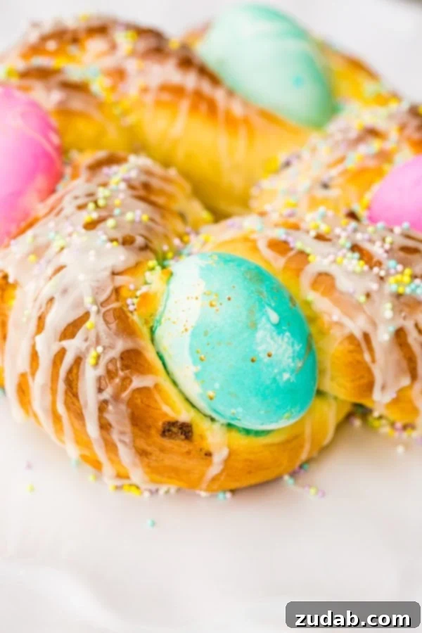 Sweet Italian Easter Bread 3 Italian Easter bread dough forming a wreath, with colorful raw eggs tucked in before baking, ready for its second rise.