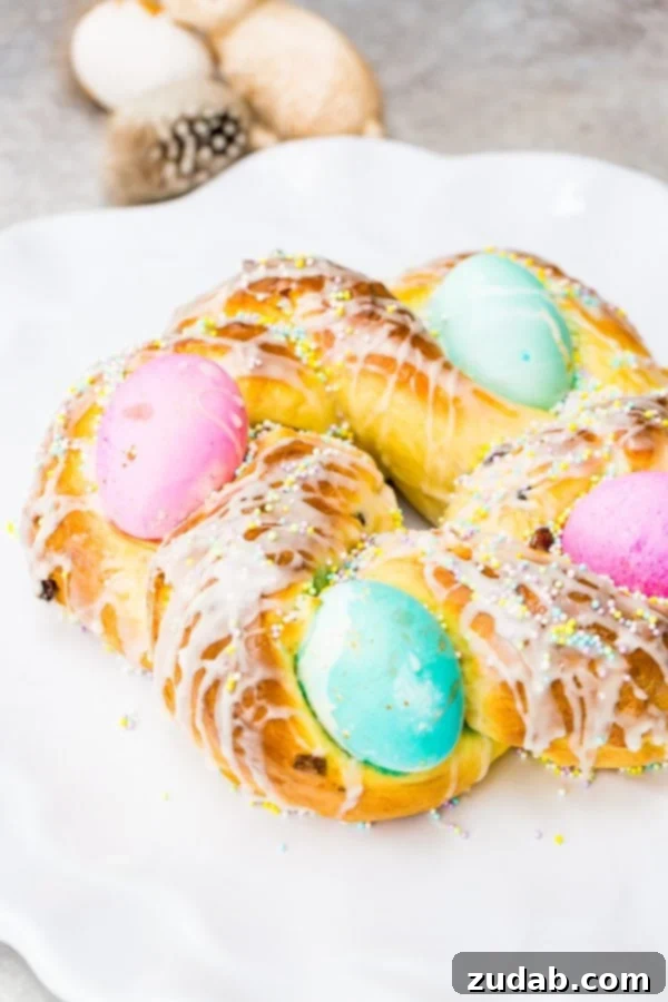Sweet Italian Easter Bread 4 A close-up of a beautifully glazed Italian Easter bread, adorned with vibrant hard-boiled eggs and colorful sprinkles, ready to be served.