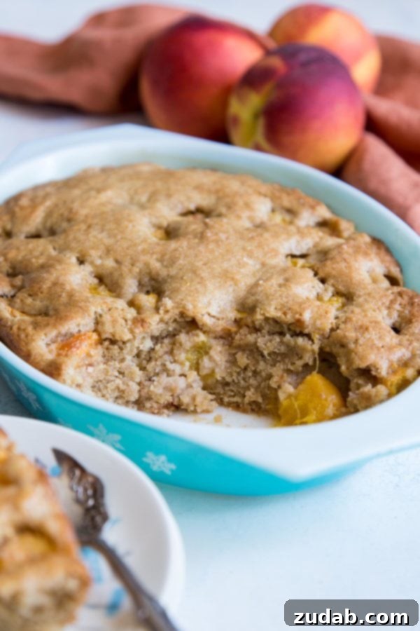 Golden Peach Butter Cake 5 Baked peach dump cake in an oval Pyrex dish