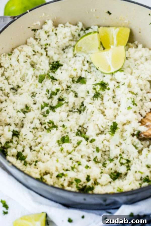 Cilantro Lime Cauliflower Rice: Your New Favorite Healthy Side Dish A vibrant photo of a pot brimming with freshly made cilantro lime cauliflower rice, garnished with bright green lime wedges, ready to be served.