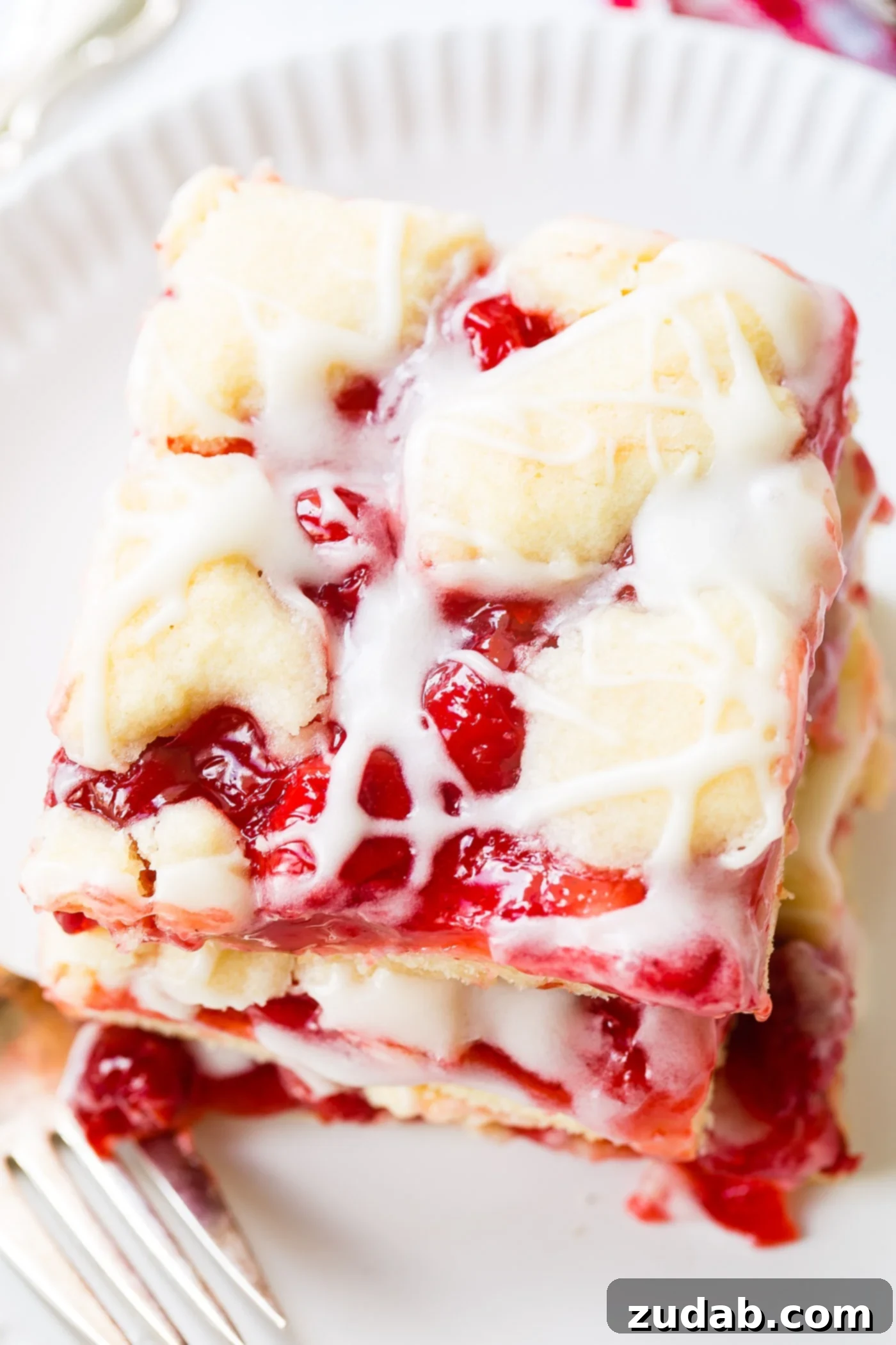 Sweet Cherry Sugar Cookie Bars 3 A beautifully composed stack of three cherry pie bars, showcasing their golden crust and enticing glaze.