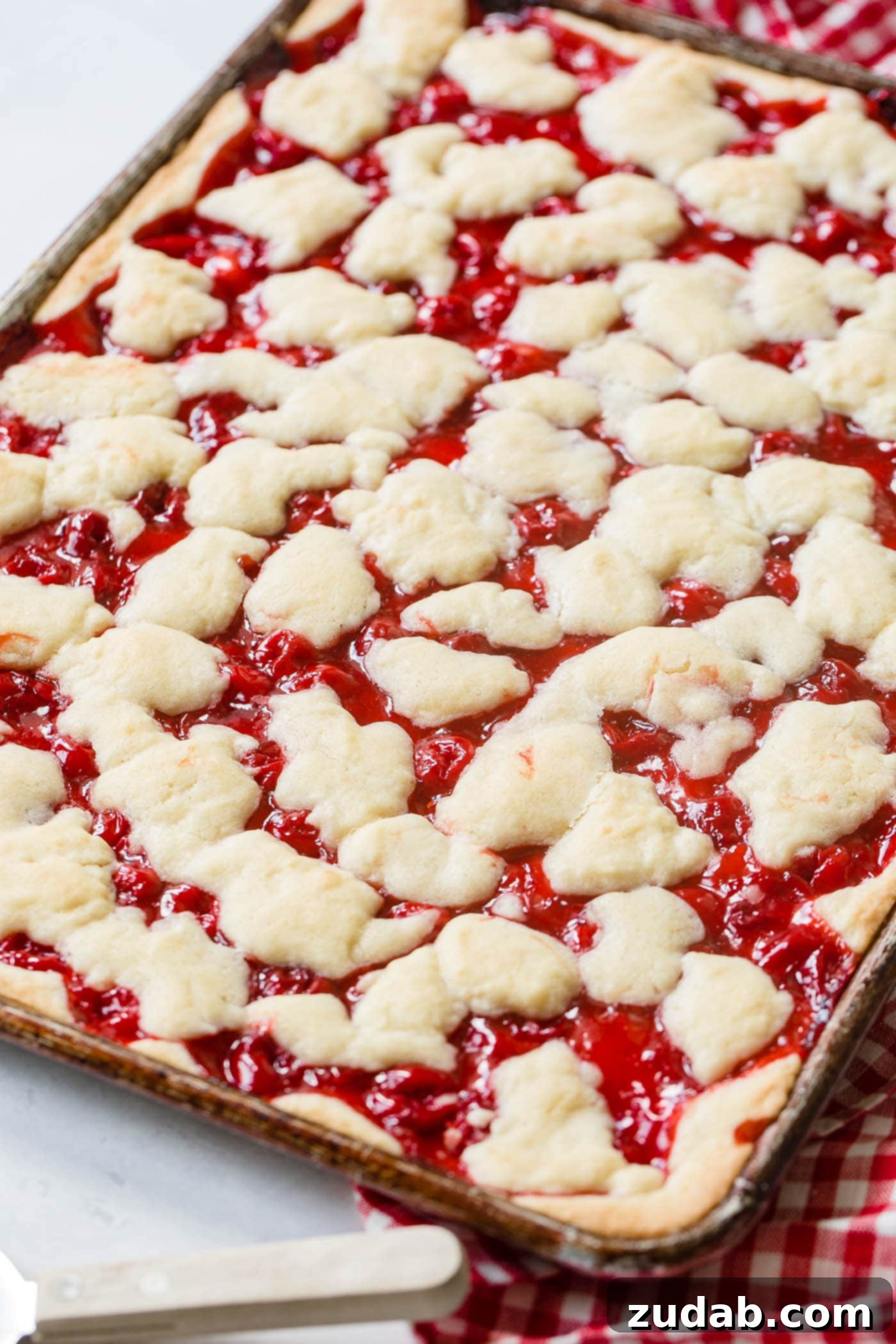 Sweet Cherry Sugar Cookie Bars 4 Cherry pie bars cooling in a sheet pan before the final touch of glaze.
