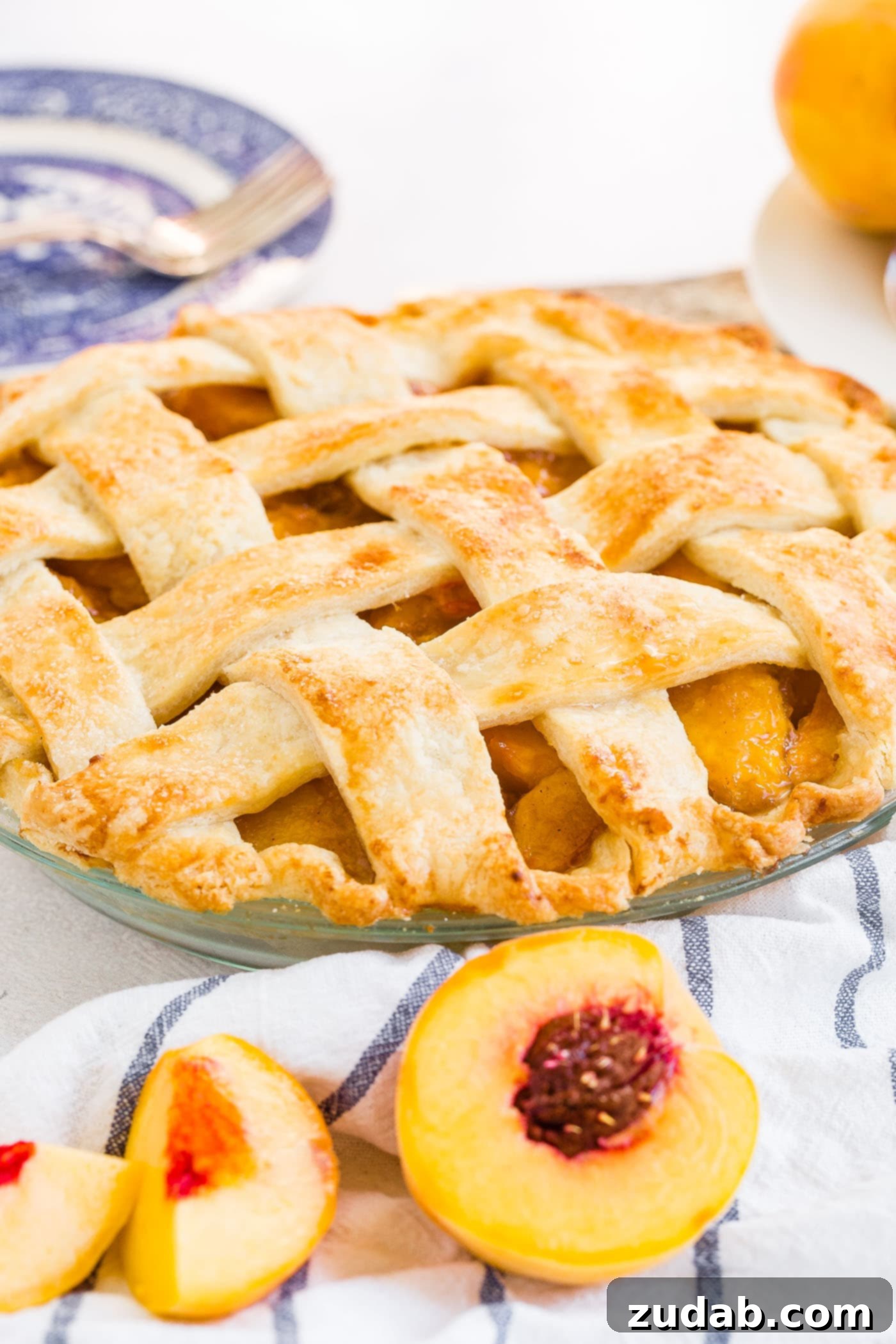 Fresh Peach Pie with Lattice Crust A photo of a fresh peach pie with a beautiful golden lattice crust.