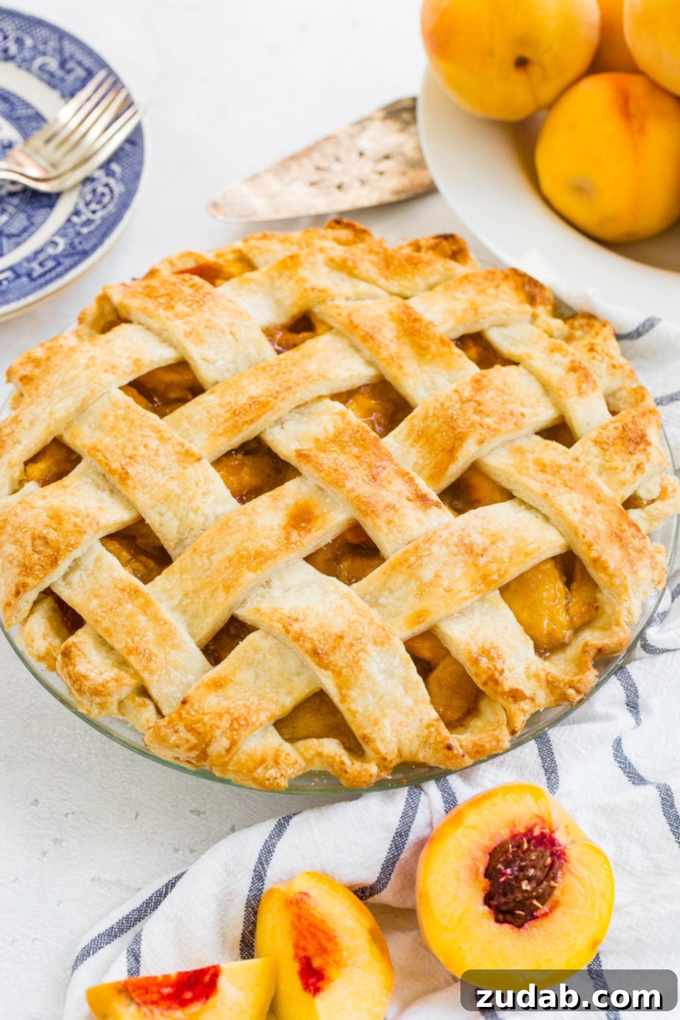 Fresh Peach Pie with Lattice Crust A photo of a fresh peach pie with a beautiful golden lattice crust.
