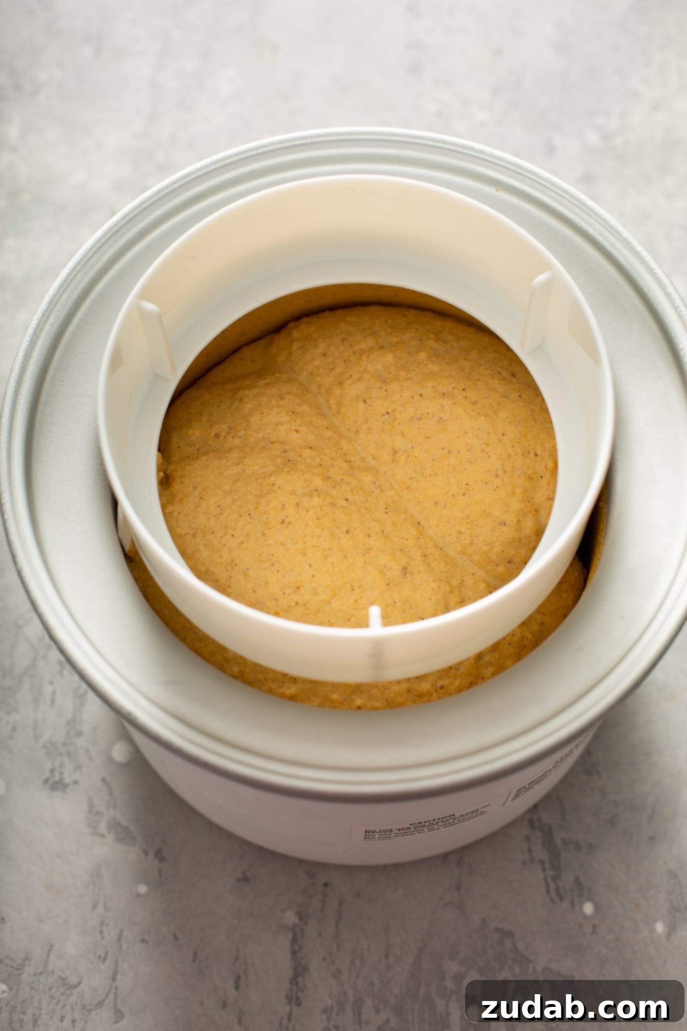 The Creamiest Pumpkin Ice Cream The cooked pumpkin custard is being strained through a fine mesh strainer.