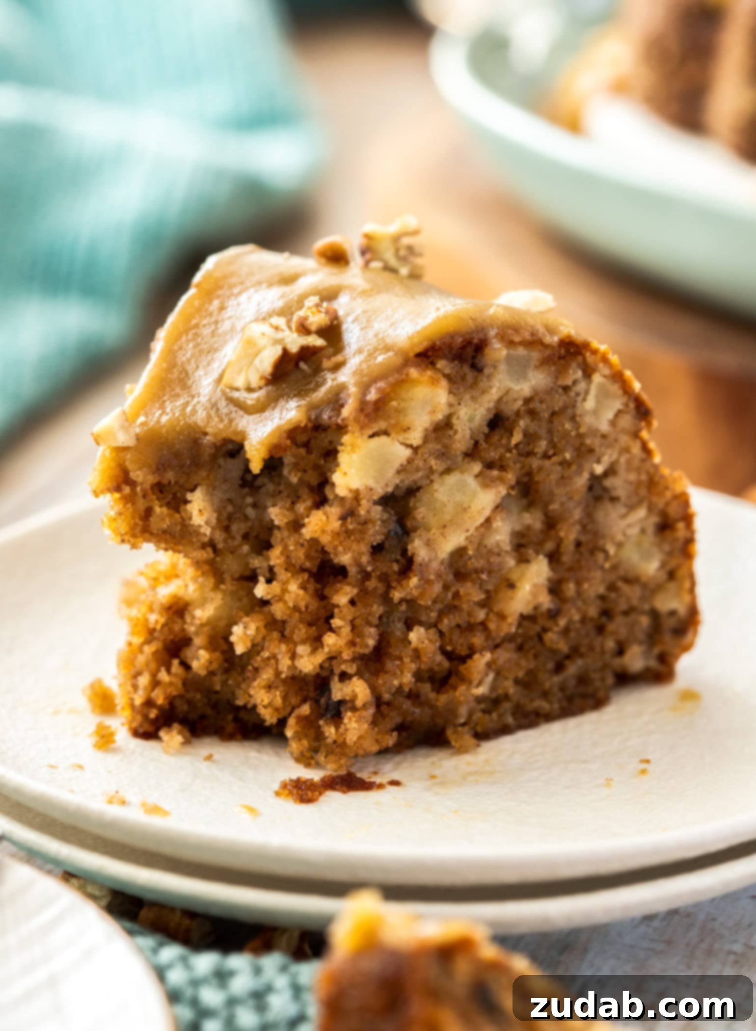 Spiced Apple Pecan Bundt 7 Closeup shot of a slice of fresh apple bundt cake with a bite taken out of it