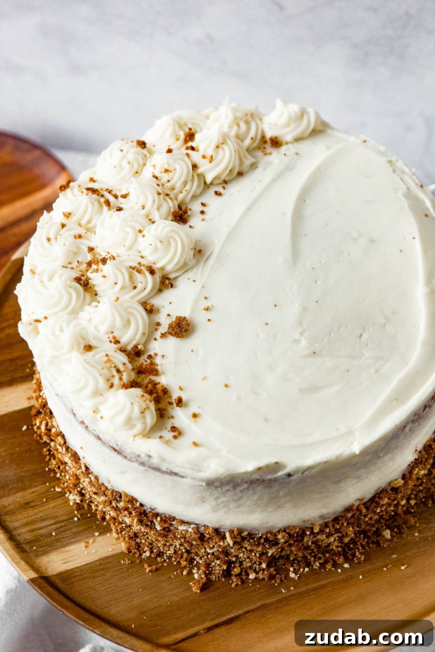 Top View of Frosted Spice Cake A beautiful top-down view of a two-layer spice cake, perfectly frosted with smooth, white cream cheese frosting.