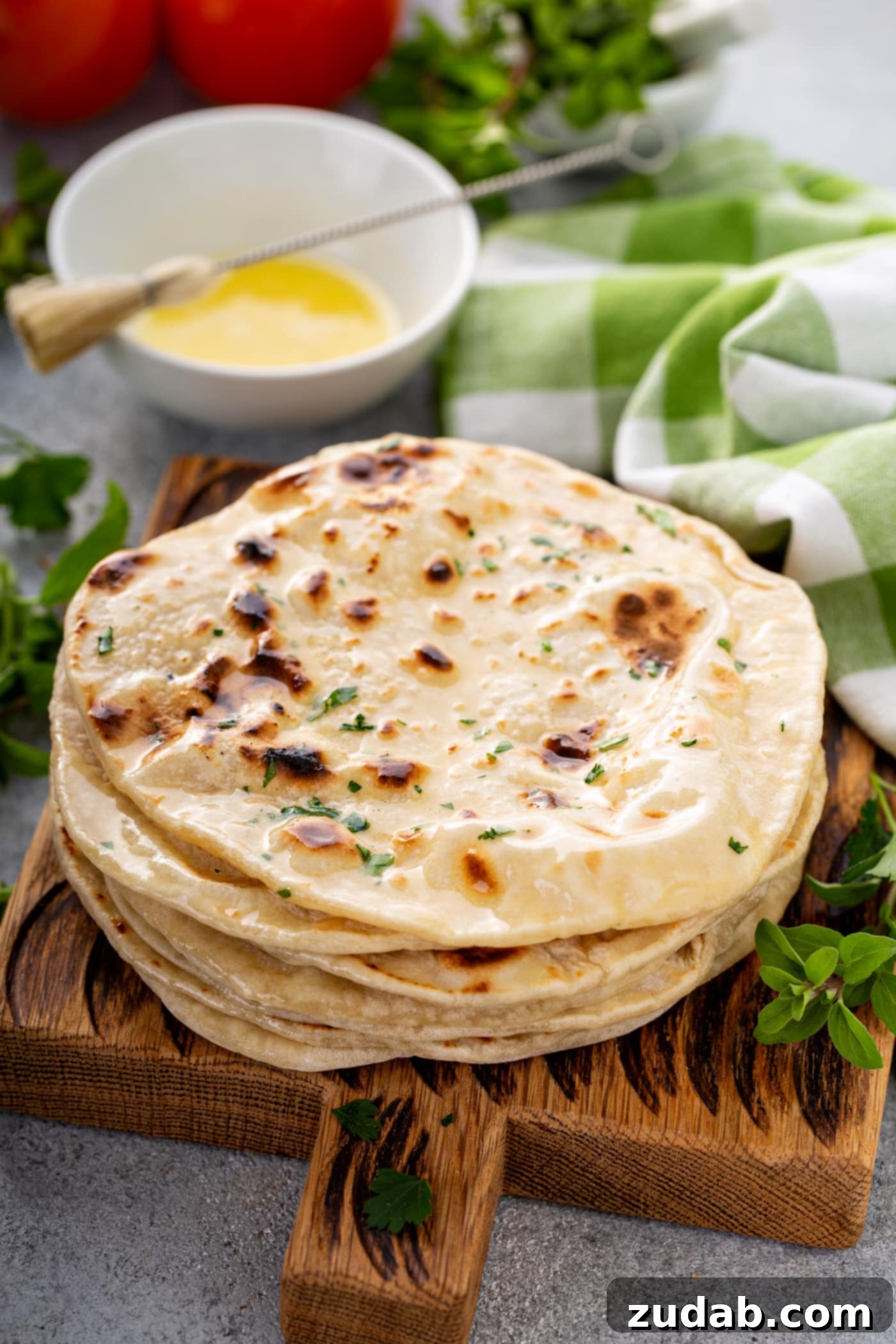 Unleavened Bread A photo of a stack of cooked discs of unleavened bread topped with chopped fresh herbs.
