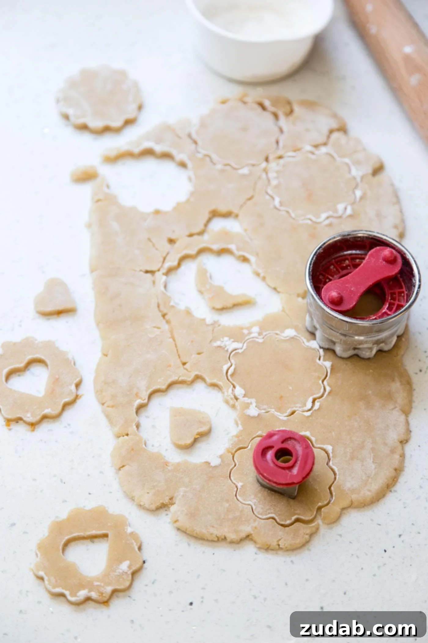 Classic Linzer Cookies 3 Close-up of cutting Linzer cookie dough with a heart-shaped cutter