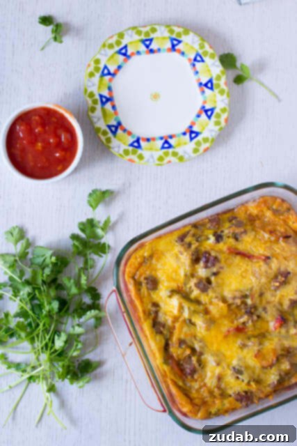 Sunrise Enchiladas 2 Mexican Breakfast Enchiladas: Wholesome whole wheat tortillas layered with savory sausage, crisp peppers, sweet onions, and fluffy eggs for a delightful morning meal.