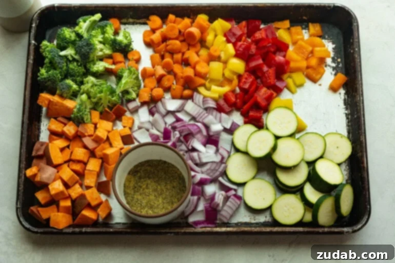 Roasted Veggies A sheet pan with zuchinni, carrots, sweet potato, bell pepper, onion, broccoli, and a spice blend