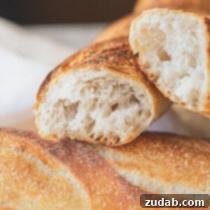 Easy Homemade Baguette Recipe 6 A freshly baked homemade baguette, showcasing its crispy crust and golden color.