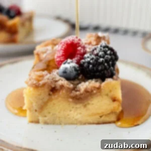 A photo of a piece of french toast casserole topped with fresh berries