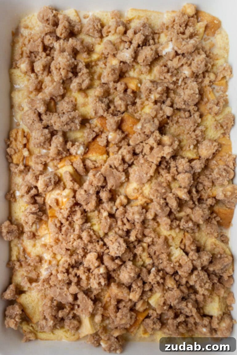 An unbaked French toast casserole, topped with streusel, ready for the oven.