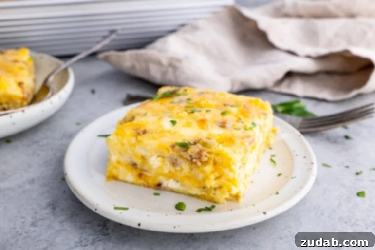 The Ultimate Sausage and Cheese Breakfast Soufflé 2 A delicious piece of cheesy sausage breakfast soufflé on a small plate, ready to be enjoyed.