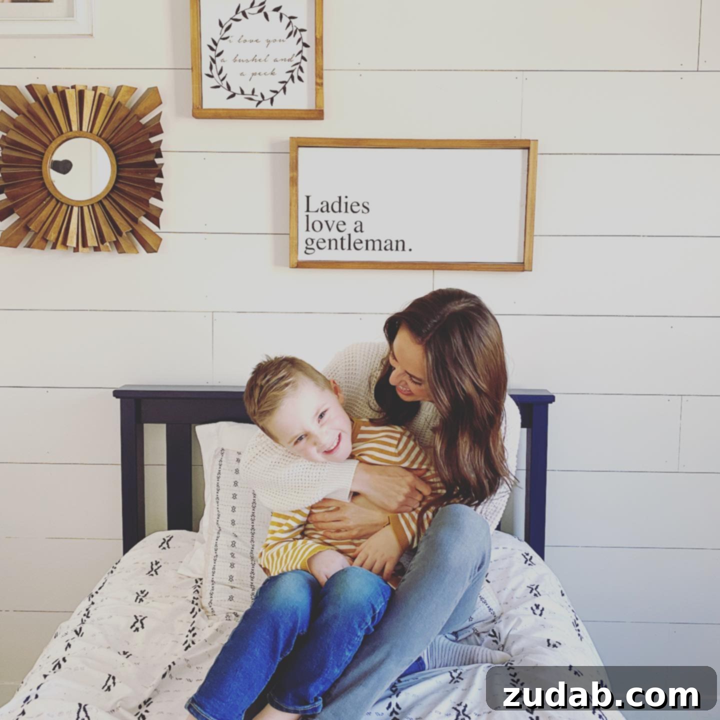Moments a photo of a mom holding her young son and laughing