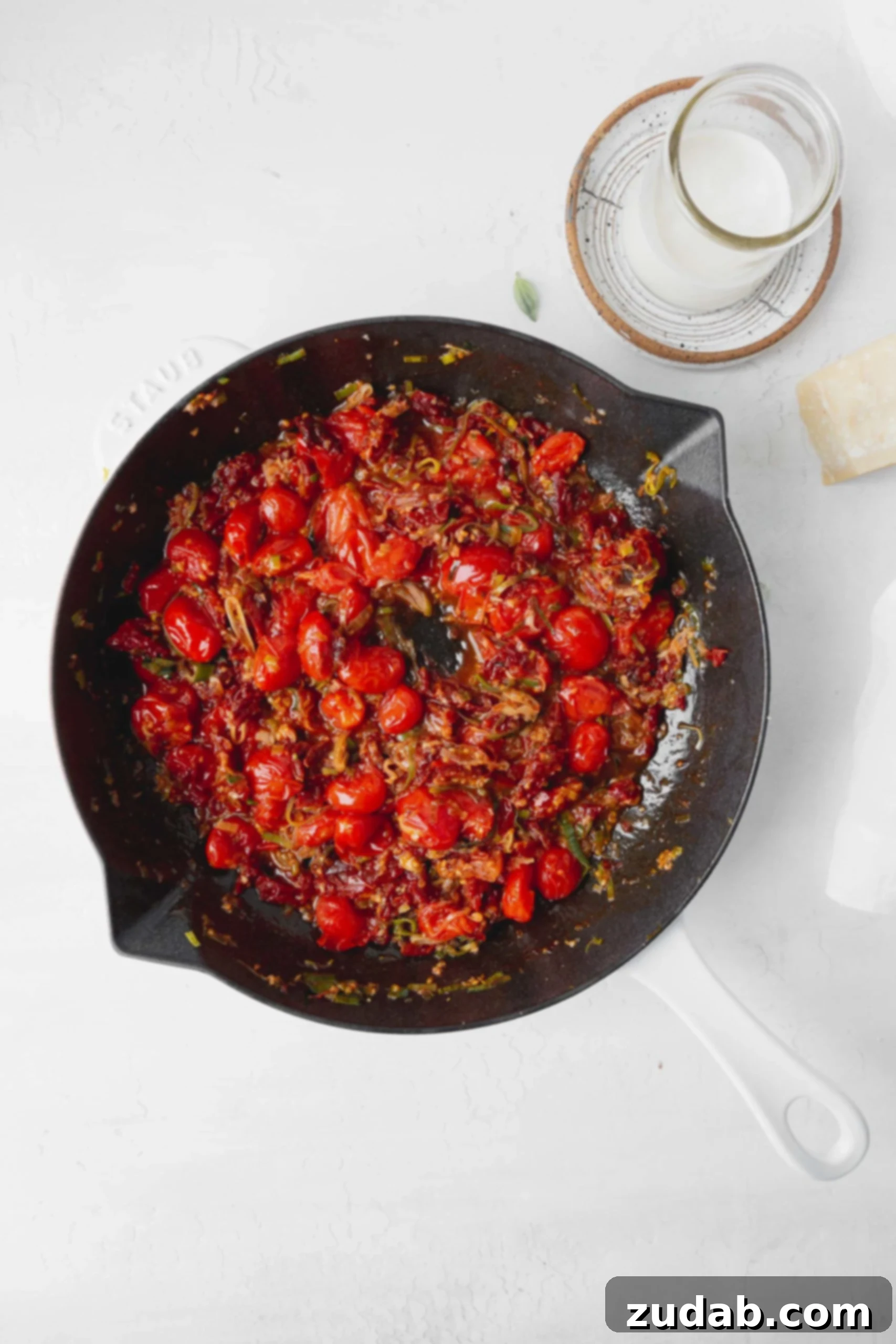 Cooked Cherry Tomatoes and Leeks A skillet showcasing cooked-down cherry tomatoes and tender leeks, forming a rich and flavorful base for the gnocchi sauce.