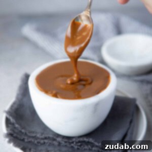 Rich homemade dulce de leche in a jar, ready for use.