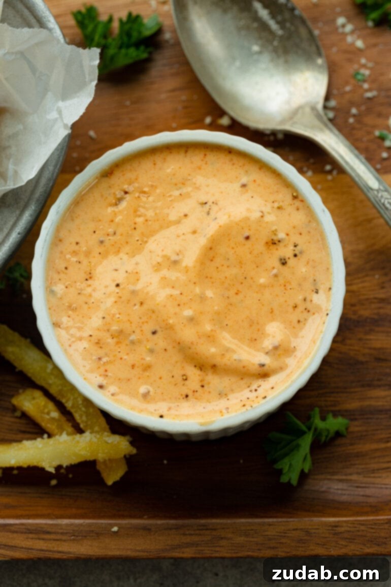 Disneyland's Iconic French Fry Recipe 5 A photo of a small ramekin full of a rich, creamy Cajun dipping sauce, ready to be enjoyed with french fries.