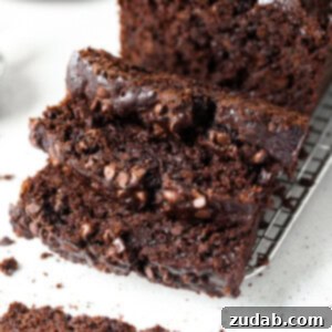 Decadent Double Chocolate Zucchini Fudge Loaf 2 A close-up image of a slice of Double Chocolate Zucchini Bread, showing its rich texture