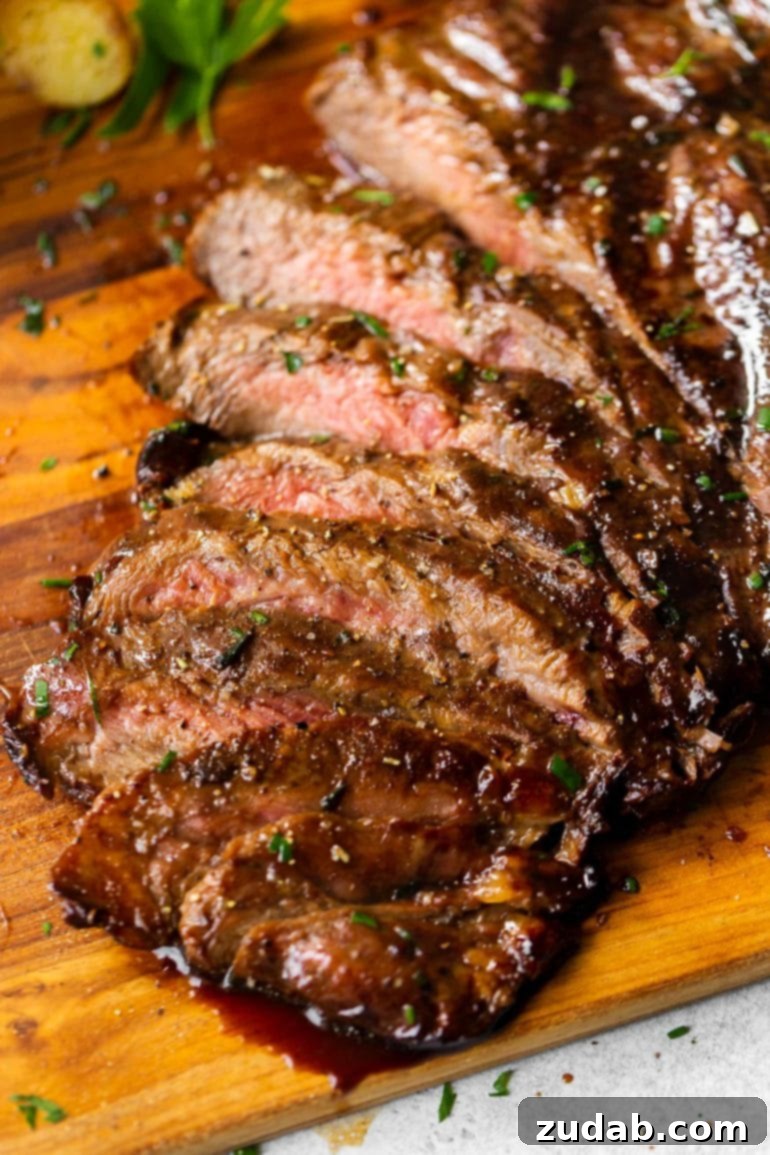 Weekly Meal Planner September 11 to 17 7 Thinly sliced, perfectly grilled flank steak that has been marinated all day in a rich balsamic marinade, showcasing its tender texture and deep flavor.